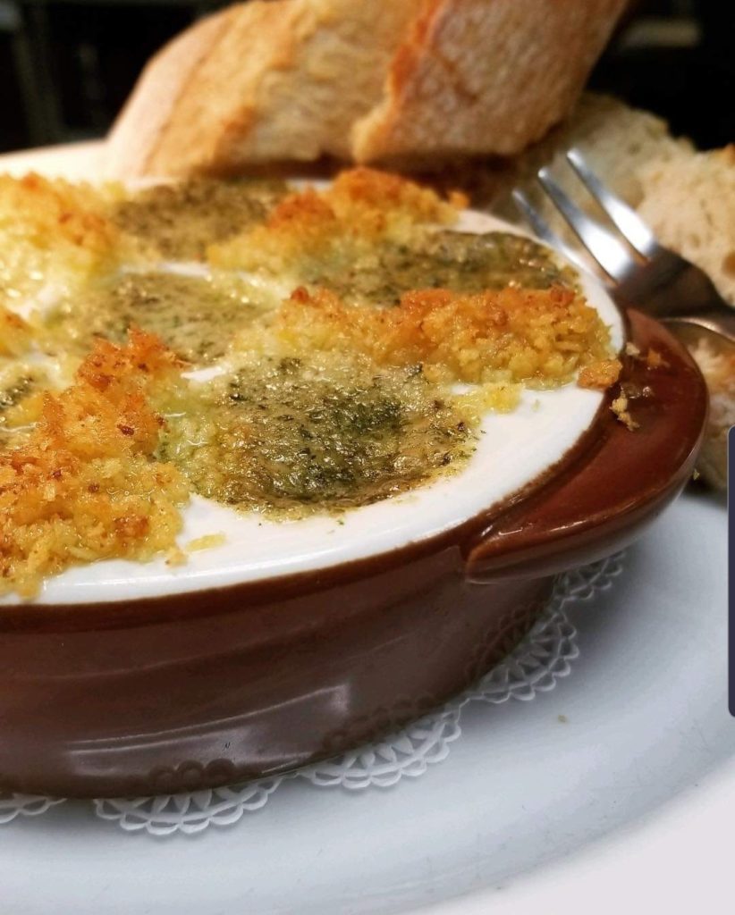 Bistro Style Escargot with French Helix Snails, Shallot, Garlic, White Wine, Cognac, Parsley, Nutmeg and Butter. Served Au Gratin in a Classic Dish